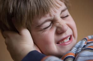 Child holding a painful ear